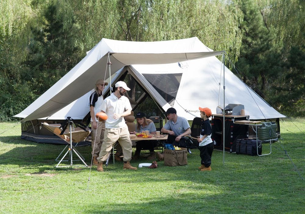 KingCamp Khan Palace glamping tent with awning and a group at camp