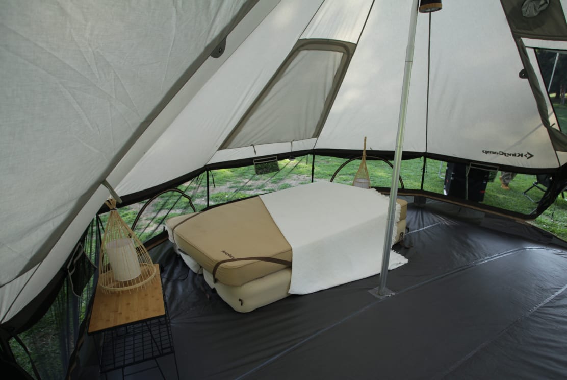 KingCamp Khan Palace sleeping wing with a bed against the vertical wall