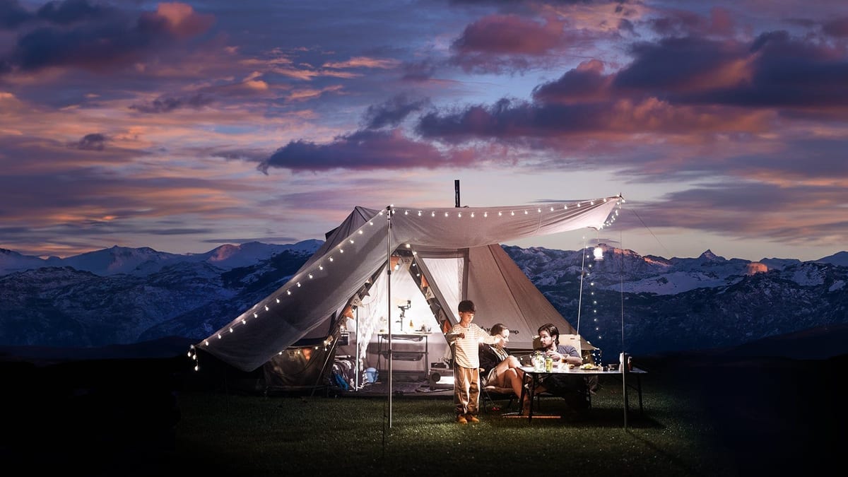 KingCamp Khan Villa bell tent pitched at dusk with string lights