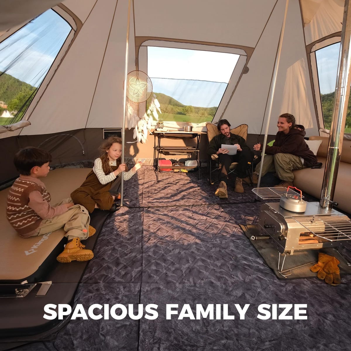 Inside the KingCamp Khan Villa: family relaxing in the middle room