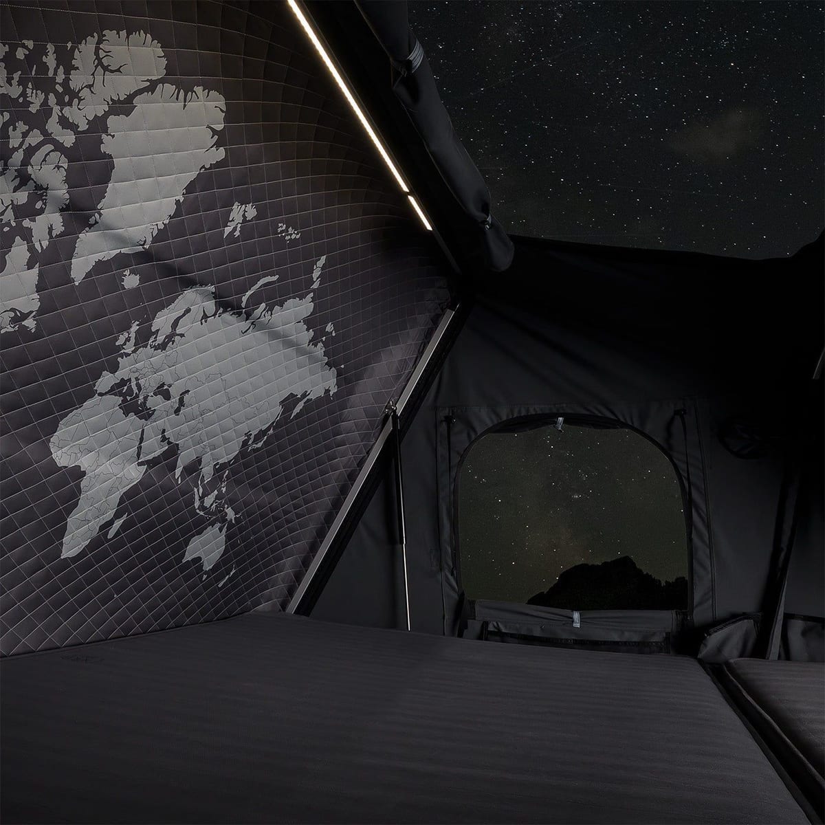Inside the iKamper Skycamp 4.0 rooftop tent at night with integrated lighting