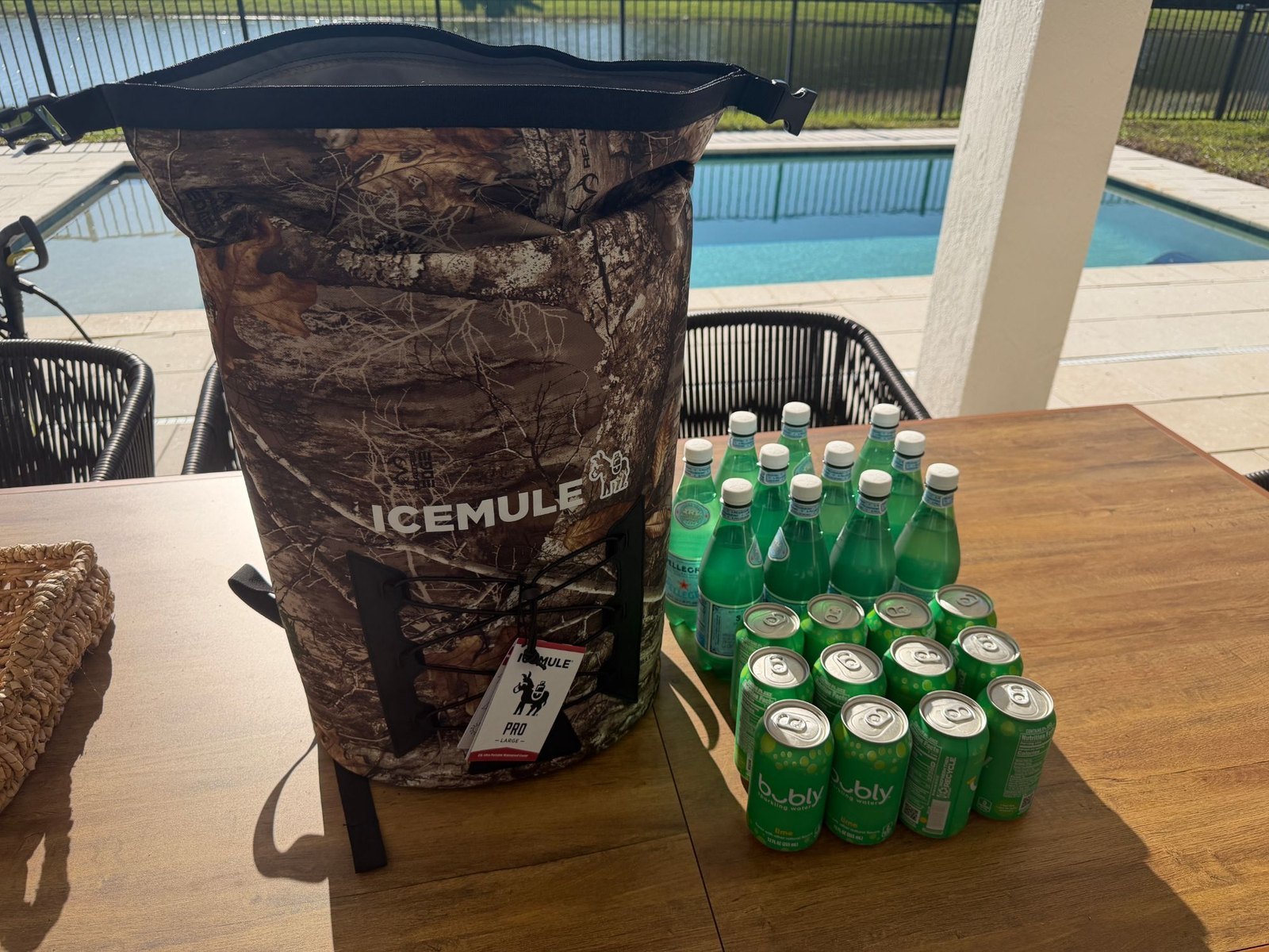 ICEMULE Pro 23L backpack cooler next to the bottles and cans we packed in it