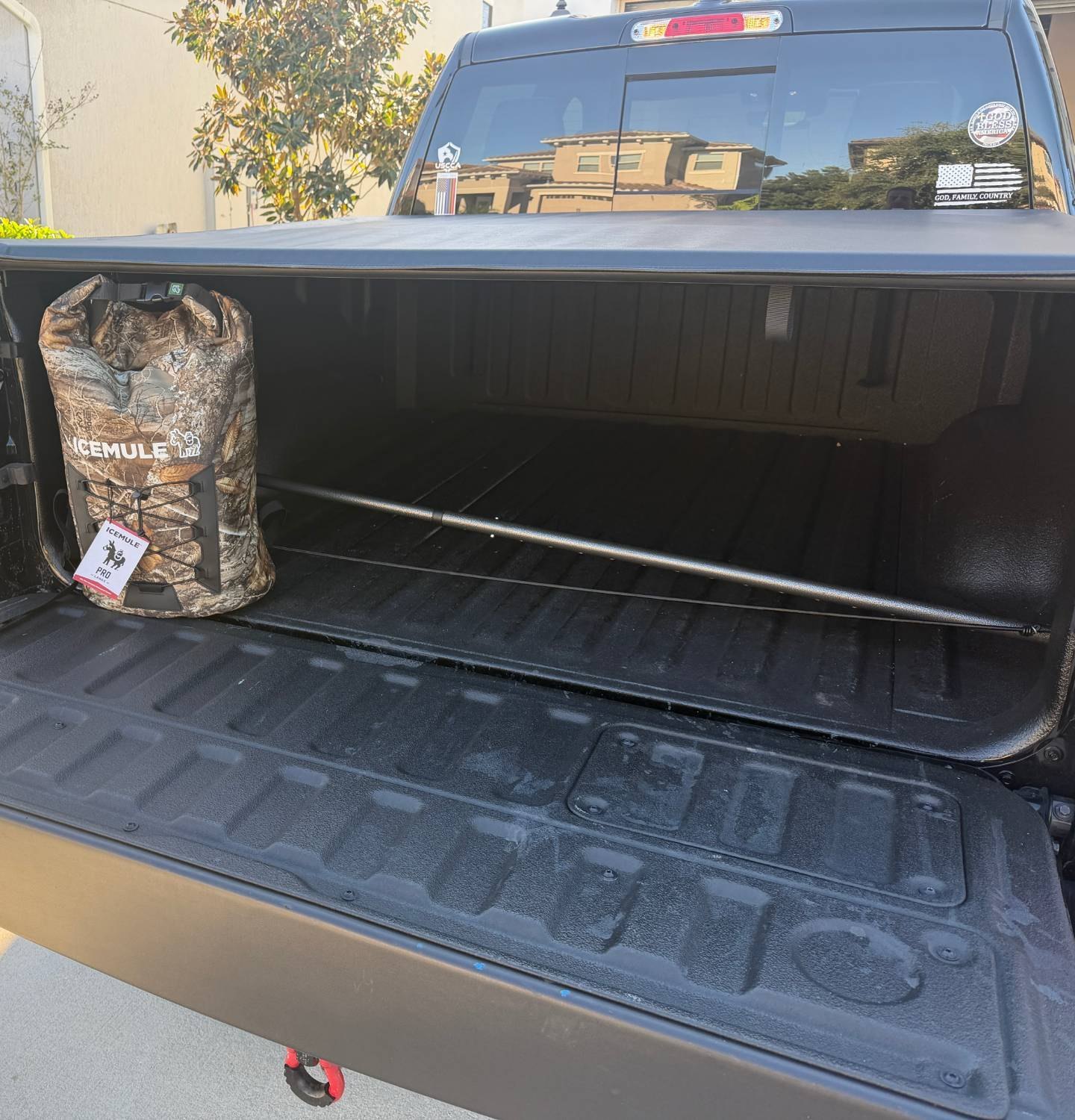 ICEMULE Pro 23L backpack cooler in Realtree Edge on the tailgate of a Ram Laramie