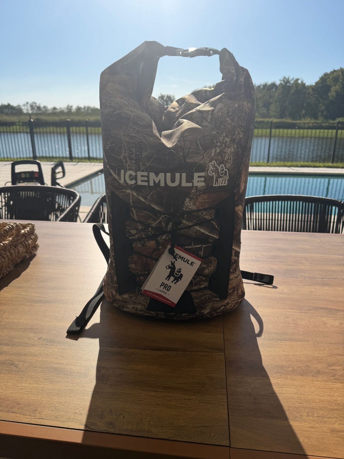ICEMULE Pro 23L backpack cooler rolled and clipped shut on a table