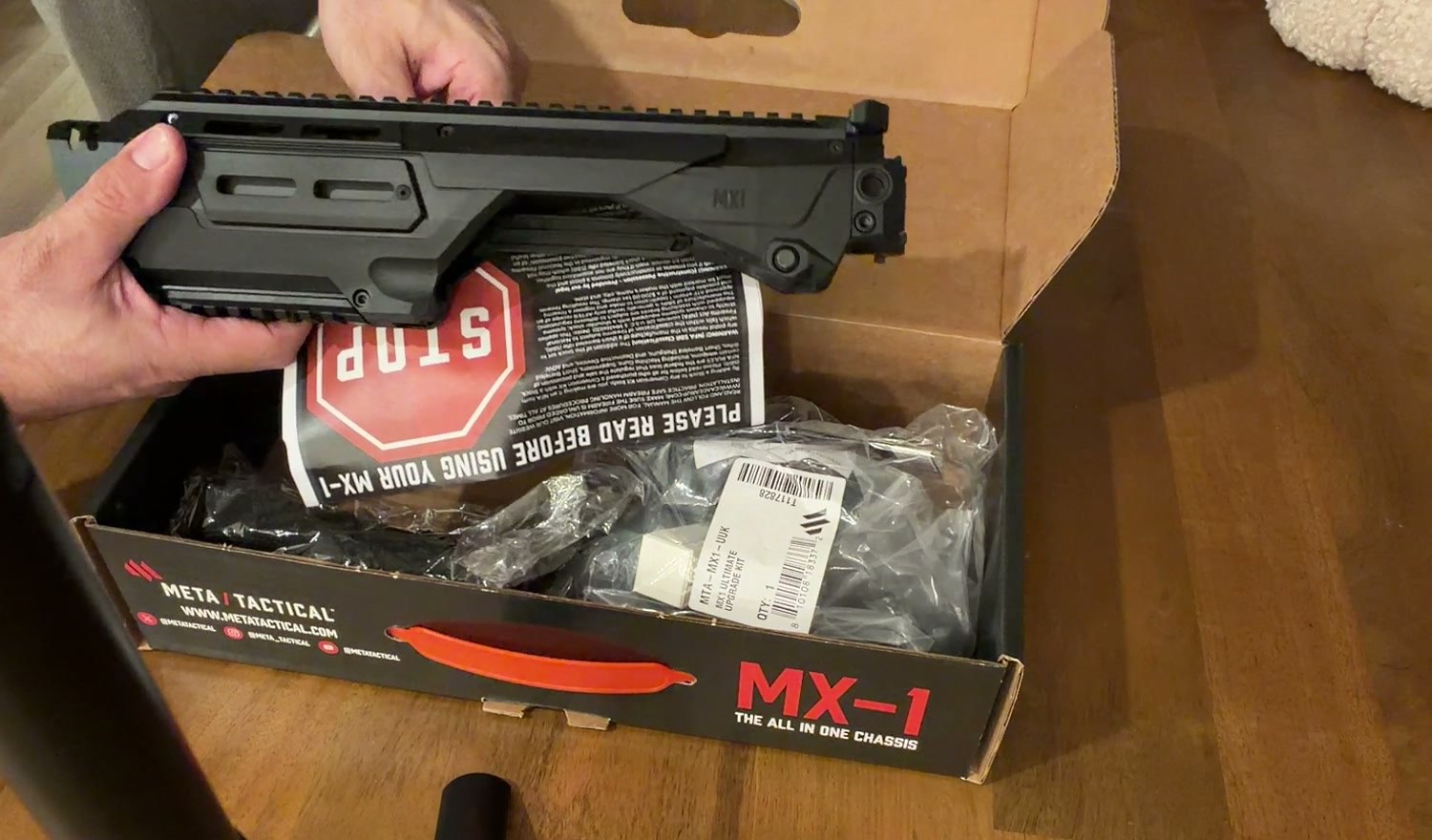 Meta Tactical MX-1 chassis out of the box next to the Please read before using your MX-1 card