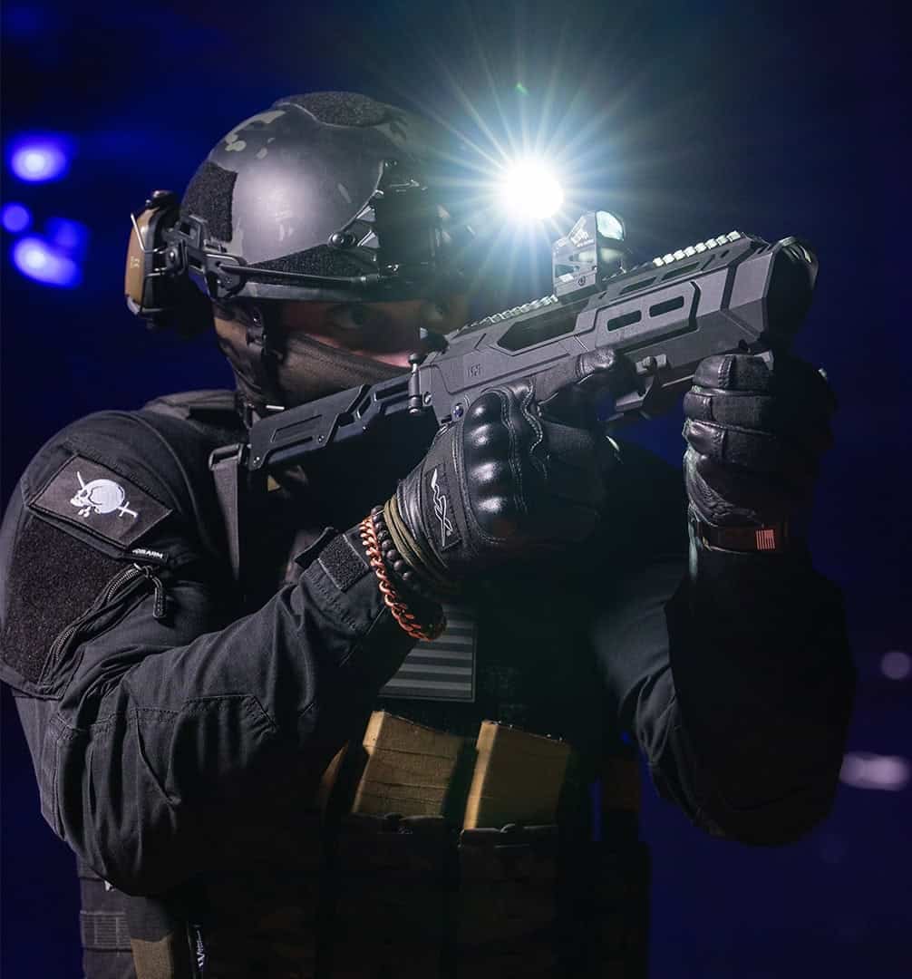 Shooter aiming a Meta Tactical MX-1 with a weapon light on